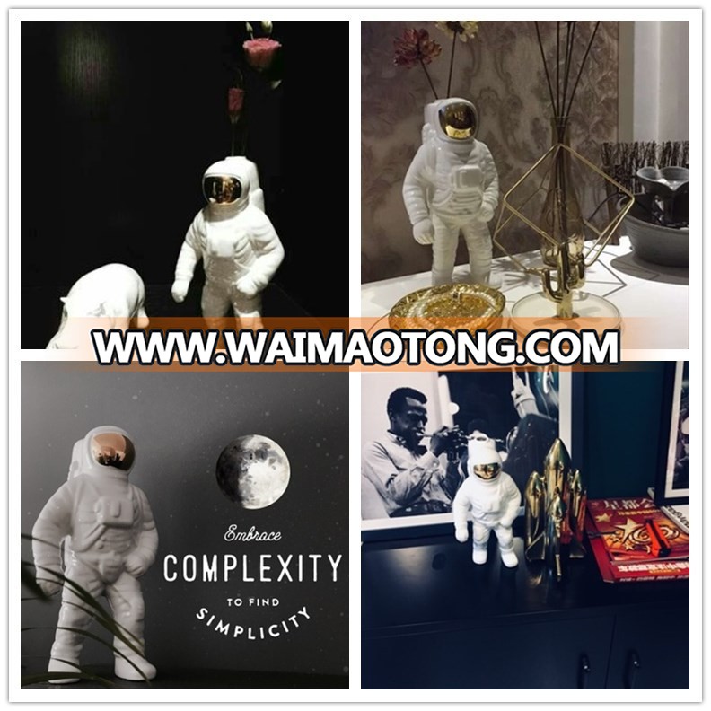 silver and gold plated astronaut model for office table design photos