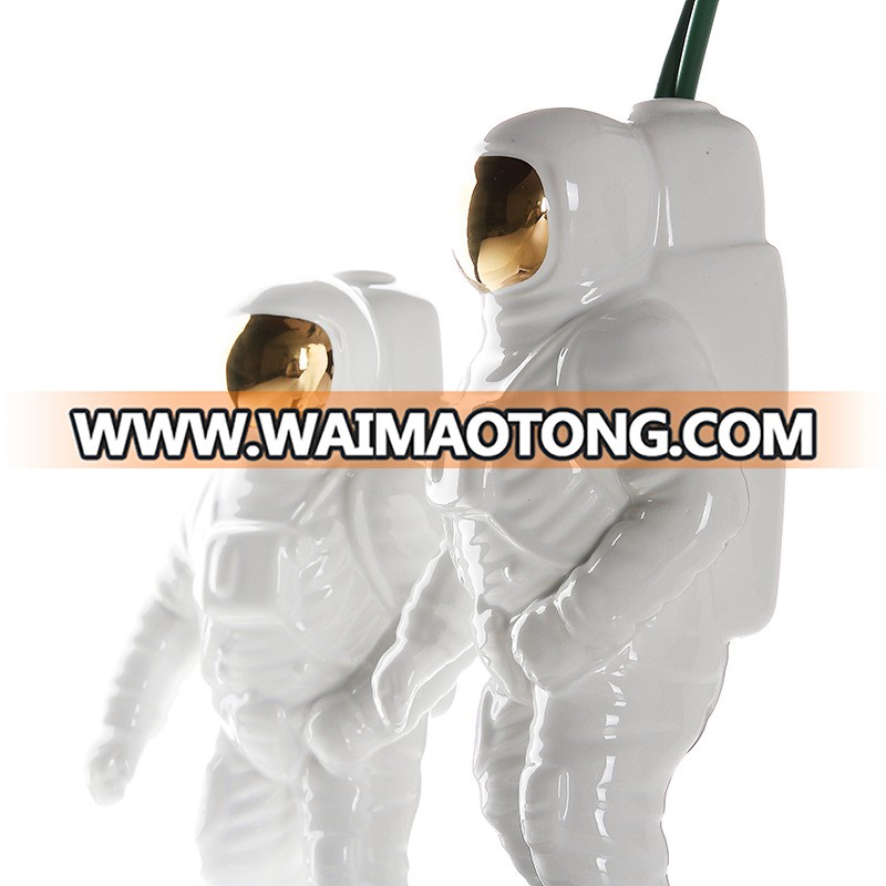 silver and gold plated astronaut model for office table design photos