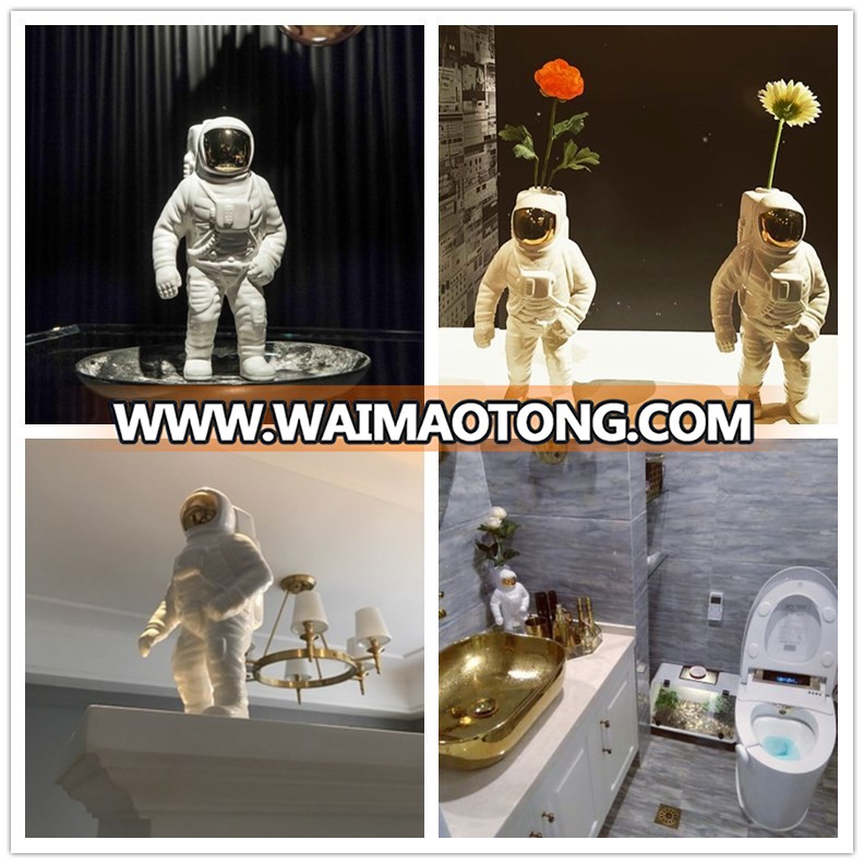 silver and gold plated astronaut model for office table design photos