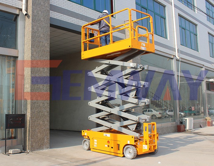 One man operating battery powered self-propelled scissor lift